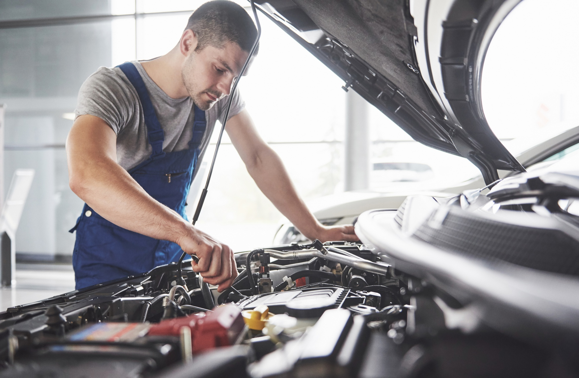 Mechanic conducting engine repair
